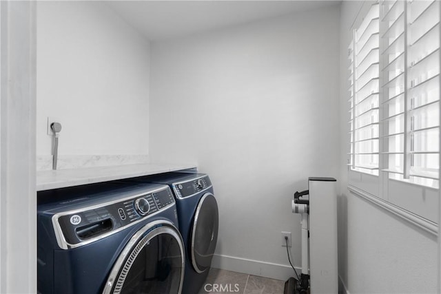 washroom featuring light tile patterned floors and washing machine and dryer