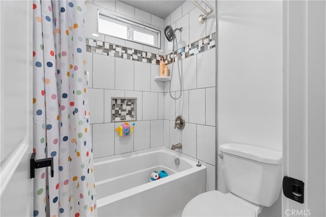 bathroom with shower / tub combo with curtain and toilet