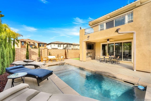 view of pool with a patio, a fireplace, and ceiling fan