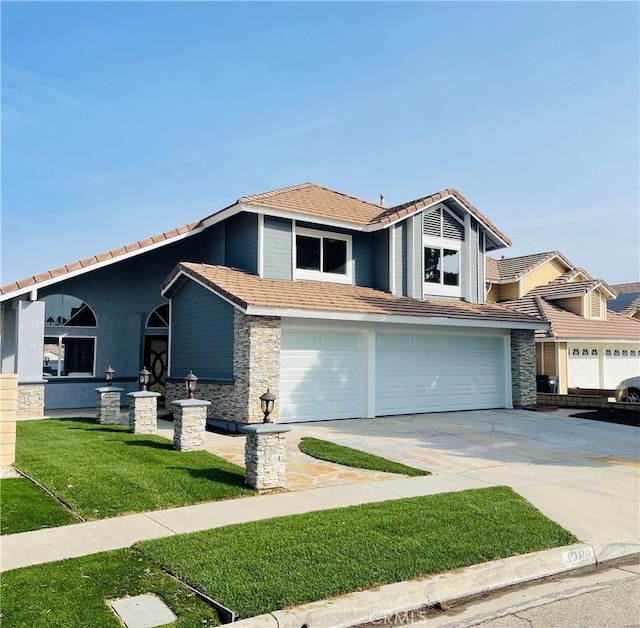 view of front of home featuring a garage and a front yard