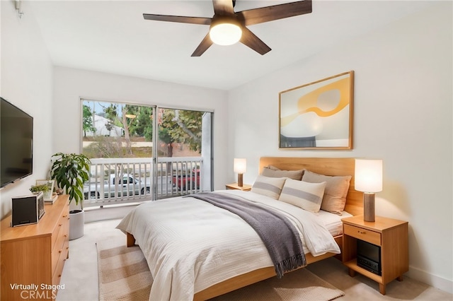 bedroom with light carpet, access to exterior, and ceiling fan