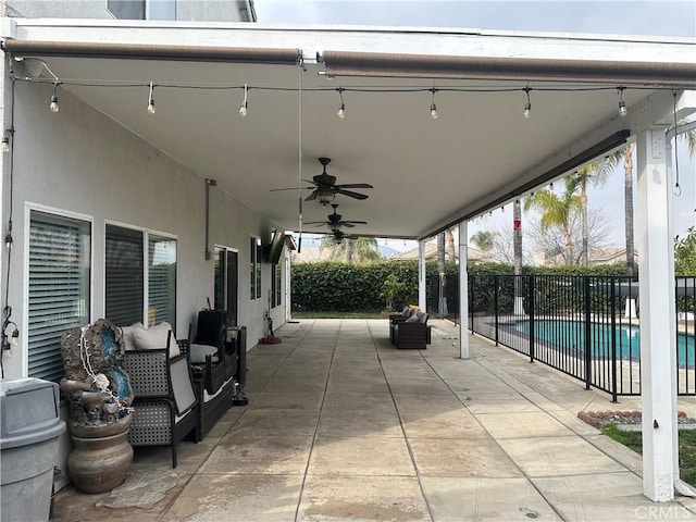 view of patio with a fenced in pool, outdoor lounge area, and ceiling fan