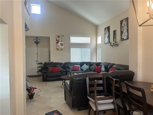 living room with high vaulted ceiling