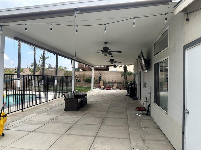 view of patio with ceiling fan and a fenced in pool