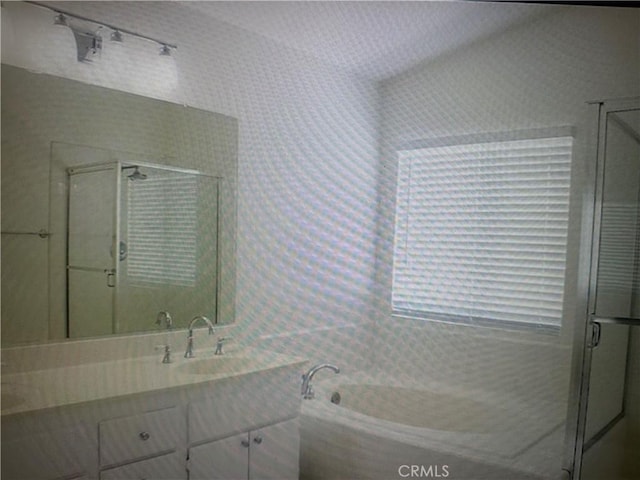 bathroom featuring shower with separate bathtub and vanity