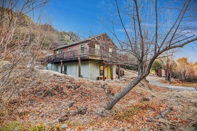 view of side of property featuring a wooden deck