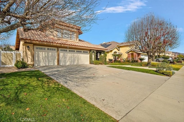 mediterranean / spanish house with a garage and a front lawn