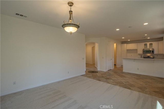 unfurnished living room featuring light colored carpet