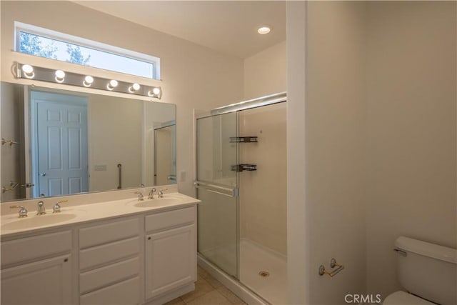 bathroom featuring walk in shower, tile patterned floors, toilet, and vanity