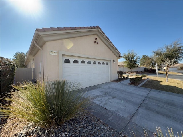 view of property exterior featuring a garage and an outdoor structure