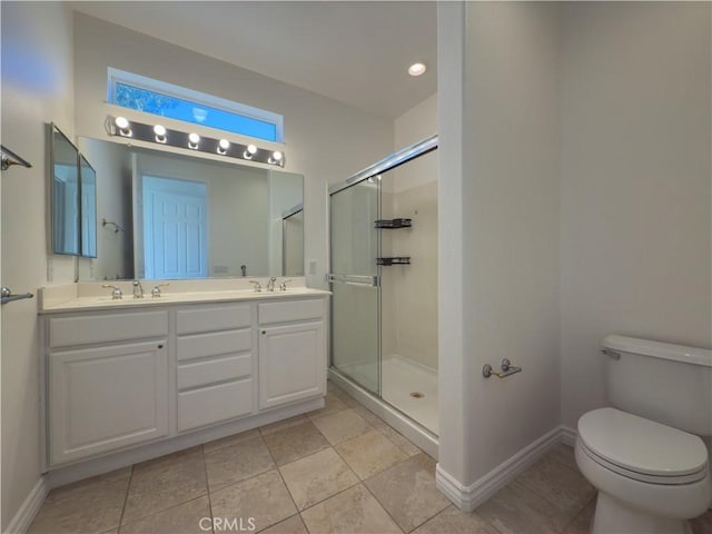 bathroom with tile patterned floors, vanity, toilet, and a shower with shower door