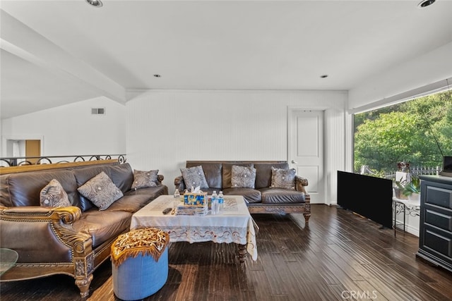 living room featuring dark hardwood / wood-style flooring and vaulted ceiling with beams