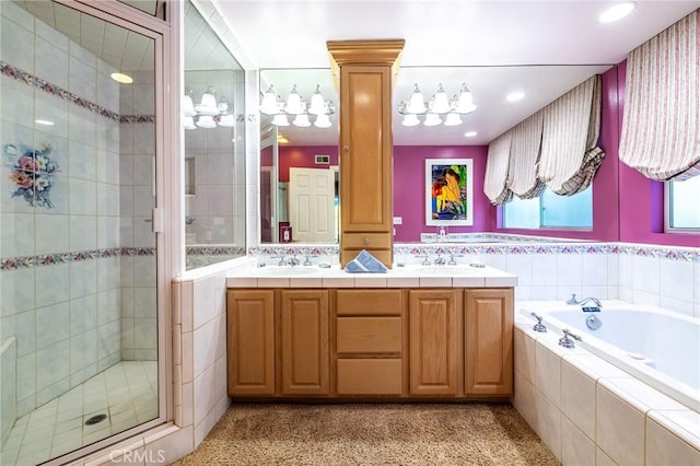 bathroom with vanity and shower with separate bathtub