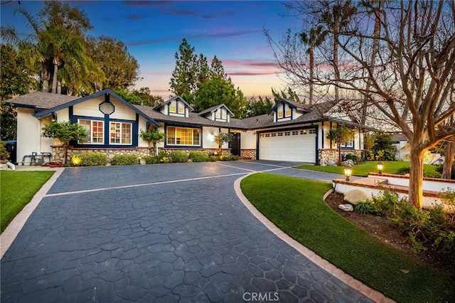 view of front facade with a garage and a lawn