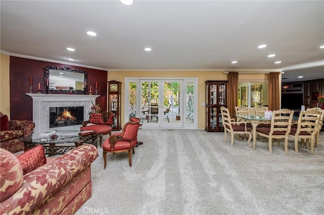 living room with crown molding, light colored carpet, and a fireplace