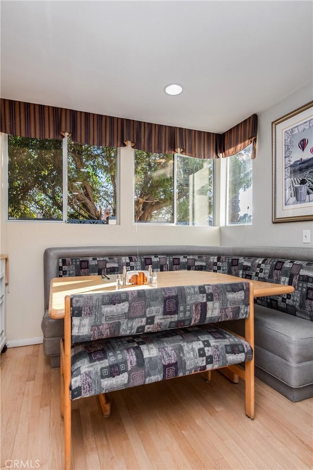 living room with light hardwood / wood-style floors and breakfast area