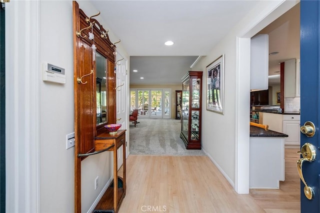 corridor with light hardwood / wood-style flooring