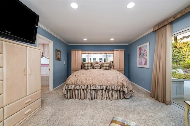 bedroom featuring crown molding, ensuite bath, and light carpet