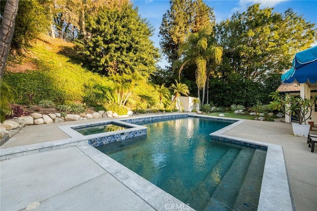 view of pool featuring an in ground hot tub and a patio area