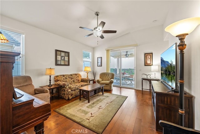 living room featuring ceiling fan, lofted ceiling, and dark hardwood / wood-style flooring