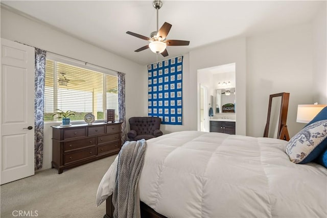 carpeted bedroom featuring ceiling fan and ensuite bathroom