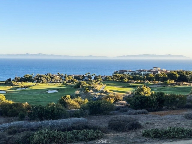 exterior space with golf course view and a mountain view