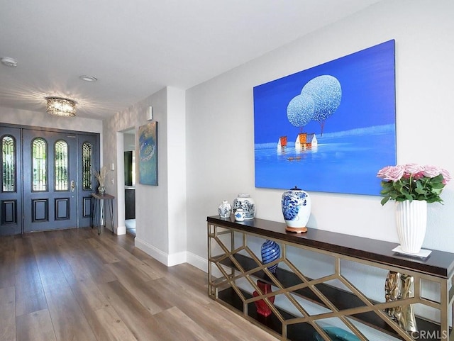 foyer entrance featuring wood finished floors and baseboards