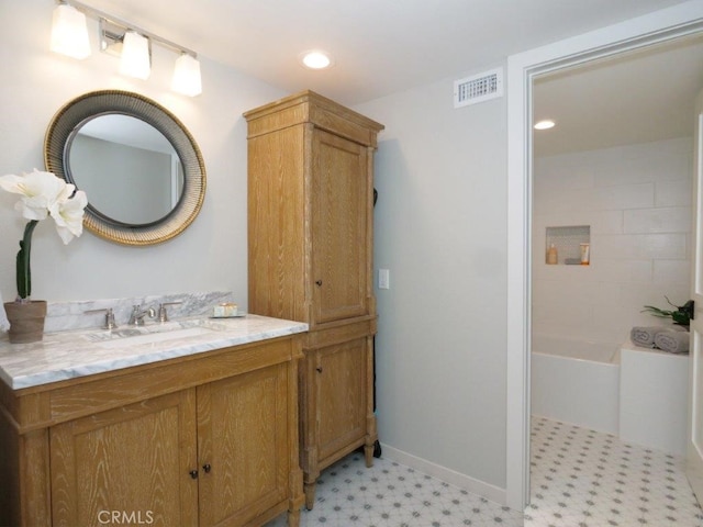 bathroom with tile patterned floors, visible vents, recessed lighting, baseboards, and vanity