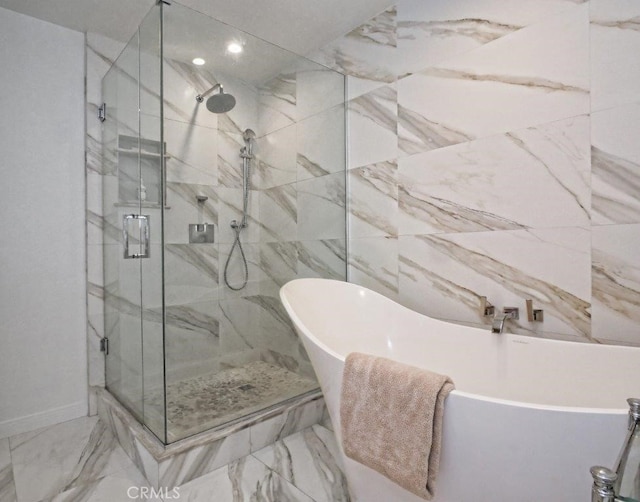 bathroom featuring shower with separate bathtub