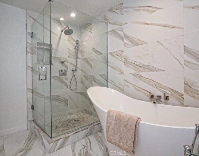 bathroom featuring a marble finish shower, a soaking tub, and marble finish floor