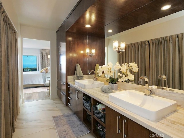 ensuite bathroom with double vanity, recessed lighting, ensuite bathroom, and a sink