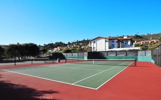 view of tennis court with basketball hoop