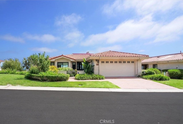 view of front of house with a tiled roof, a garage, driveway, and stucco siding