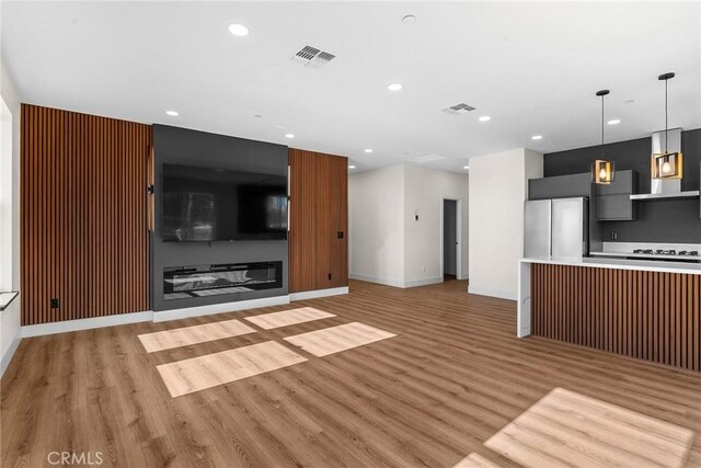 unfurnished living room featuring light hardwood / wood-style floors