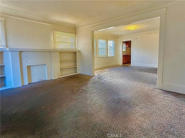 unfurnished living room with crown molding, carpet floors, a fireplace, and a textured ceiling