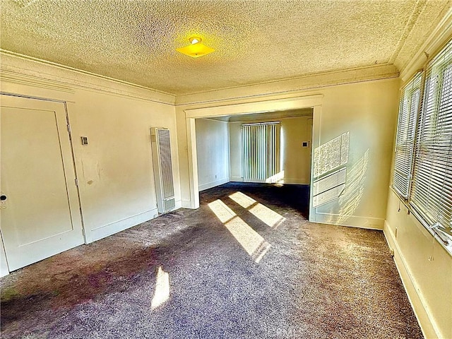 carpeted empty room featuring crown molding and a textured ceiling