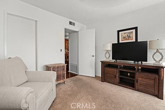 sitting room featuring light carpet