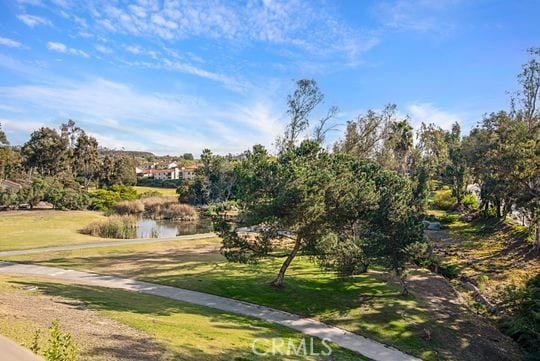 view of community featuring a water view and a lawn