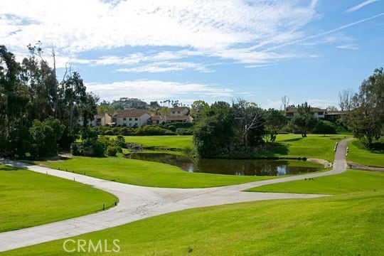 view of community with a water view and a lawn