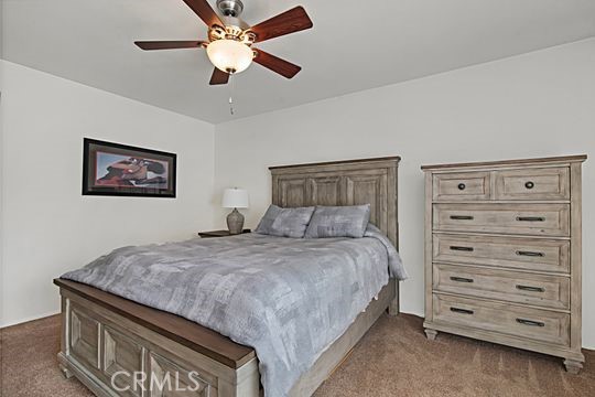 carpeted bedroom featuring ceiling fan