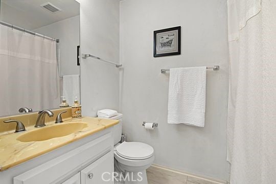 bathroom featuring vanity and toilet