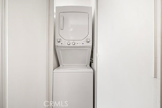 laundry room featuring stacked washing maching and dryer