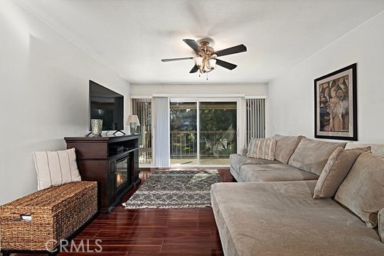 living room featuring dark hardwood / wood-style flooring and ceiling fan