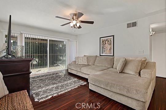 living room featuring dark hardwood / wood-style floors and ceiling fan