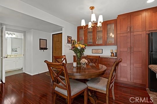 dining space featuring a notable chandelier and dark hardwood / wood-style floors