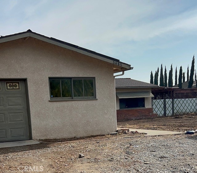 view of side of home featuring stucco siding