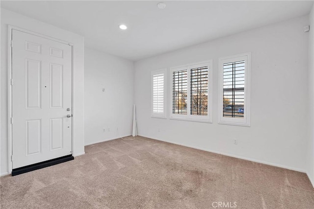 spare room with light colored carpet