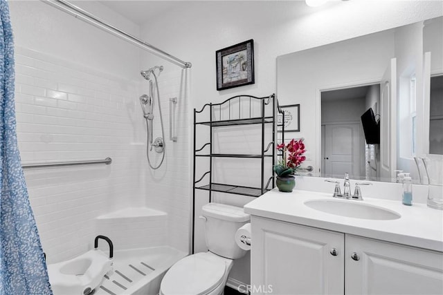 bathroom featuring vanity, toilet, and a shower with shower curtain