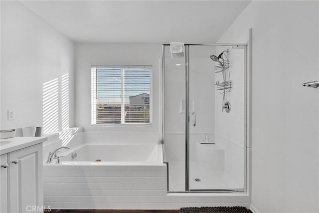 bathroom with vanity and independent shower and bath