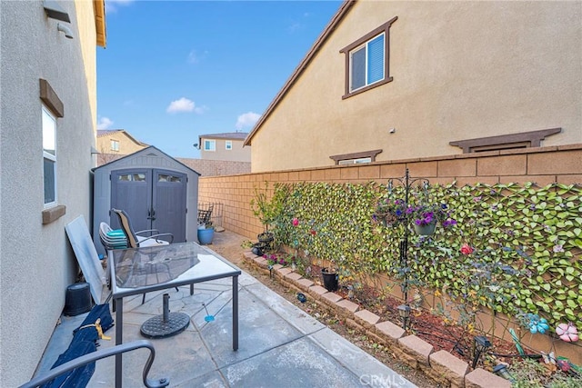 view of patio featuring a storage unit